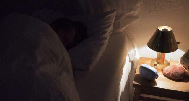 Bedwetting alarm treatment for child.  Pjama bedwetting alarm speaker on bedstand when accident the alarm sounds and wakes the child with the goal to connect the bladder with the brain