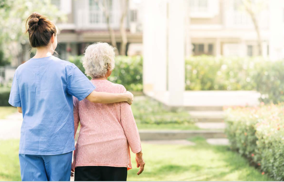 Nurse caring for woman at eldery care facility